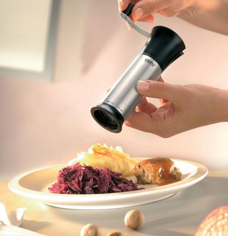 GEFU Muskatmühle Moscata Laser Cut über Teller mit Essen